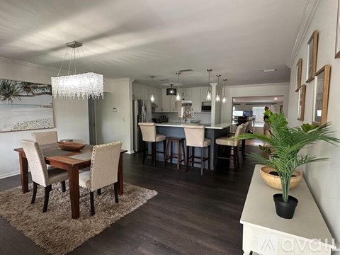 A dining room with a wooden table and chairs.