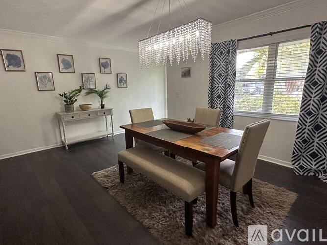 A dining room with a wooden table and chairs.