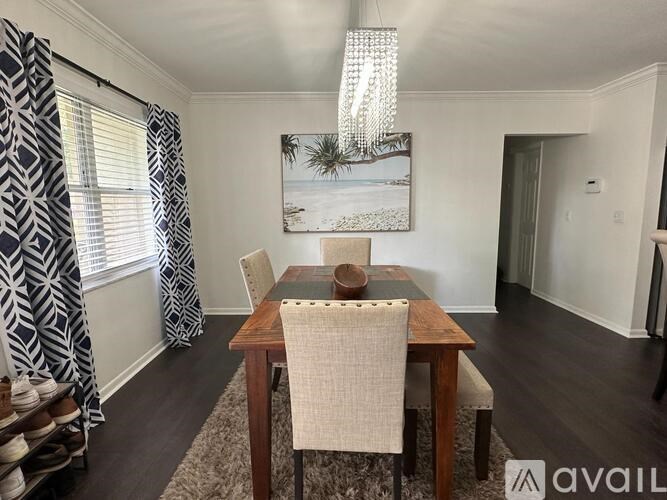 A dining room with a wooden table and chairs.