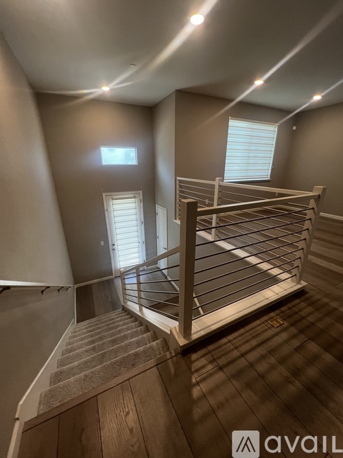 A staircase with a metal railing and wooden steps.
