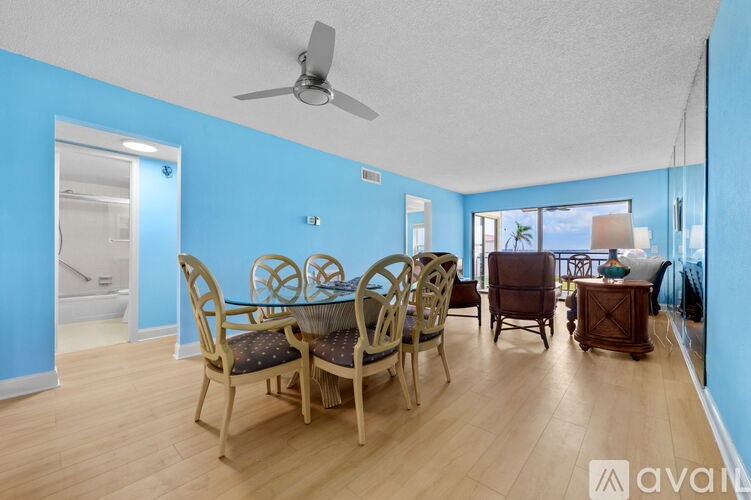 A dining room with a table and chairs.