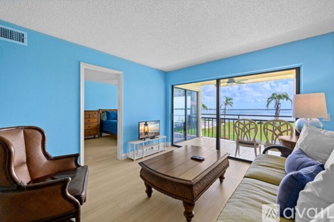 A living room with a brown leather chair and a wooden coffee table.