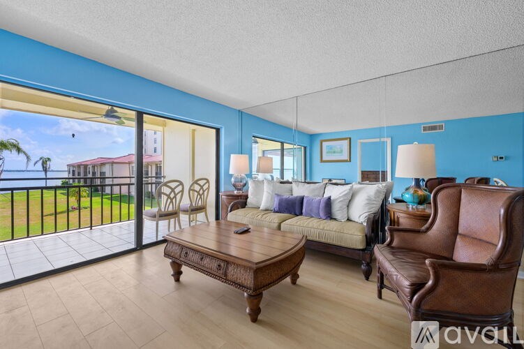 A living room with a brown leather chair and a wooden coffee table.