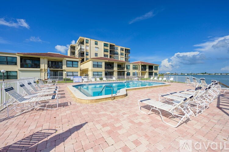 A large building with a pool in front of it.