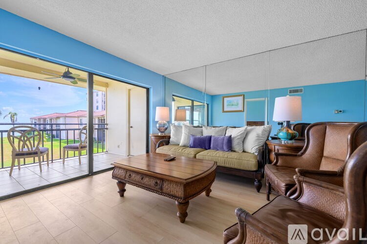 A living room with a brown leather couch and a wooden coffee table.