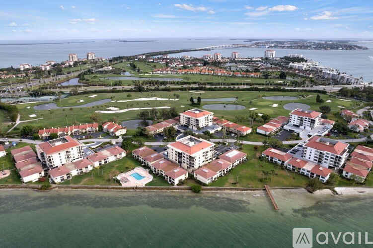 A bird's eye view of a resort with a pool and multiple buildings.