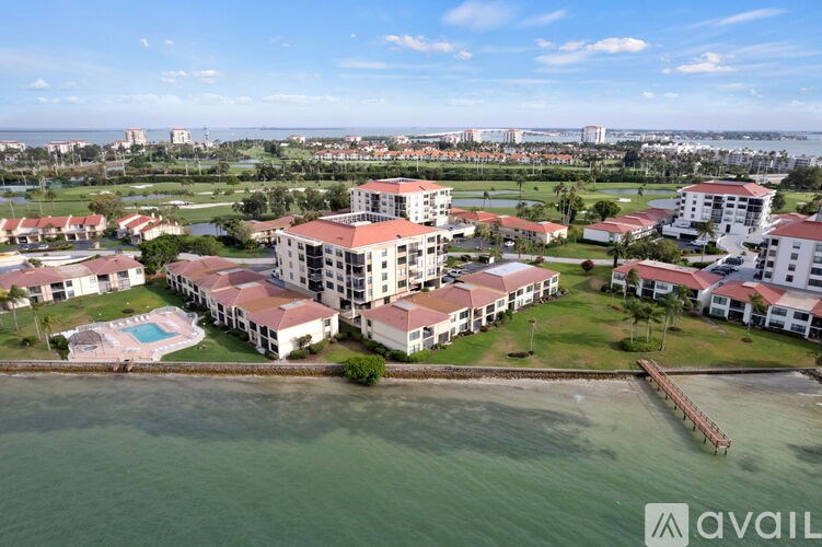 A bird's eye view of a resort with a swimming pool and buildings.