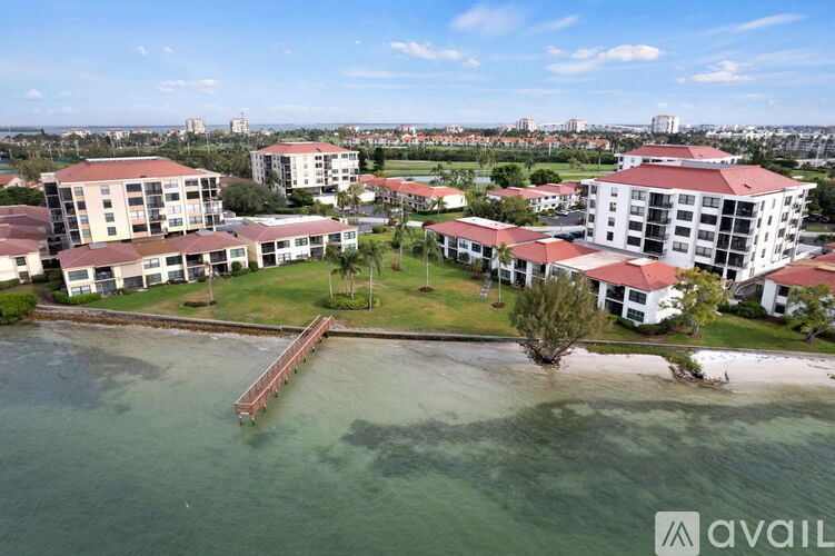 A bird's eye view of a resort with a pier extending into the water.