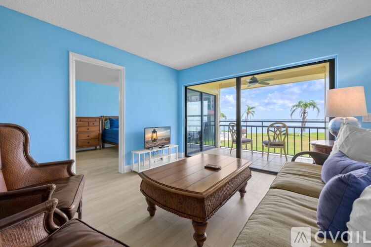 A living room with a brown leather couch and a wooden coffee table.