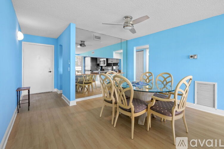 A dining room with a table set for six.