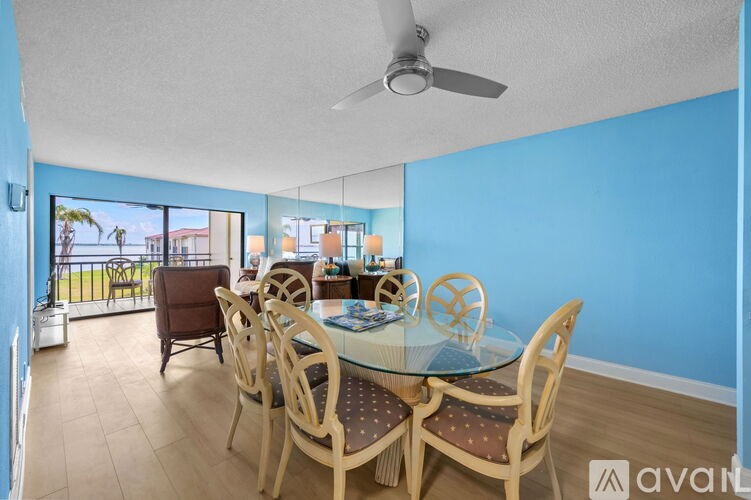 A dining room with a glass table and chairs.