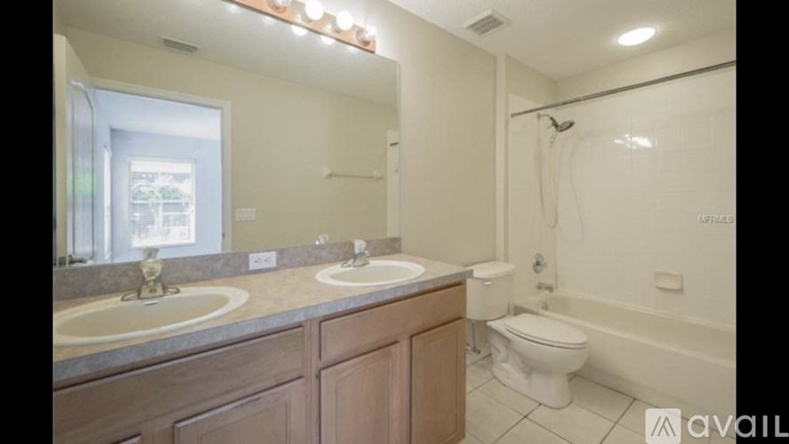 A bathroom with a toilet, sink, and bathtub.