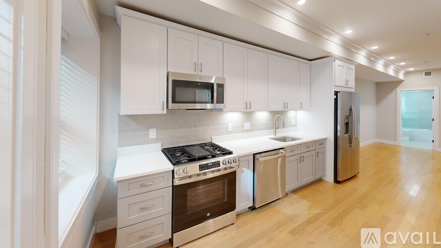 A kitchen with white cabinets and stainless steel appliances.