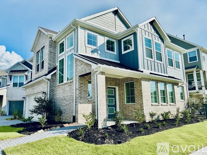A large house with a grey roof and a white garage door.