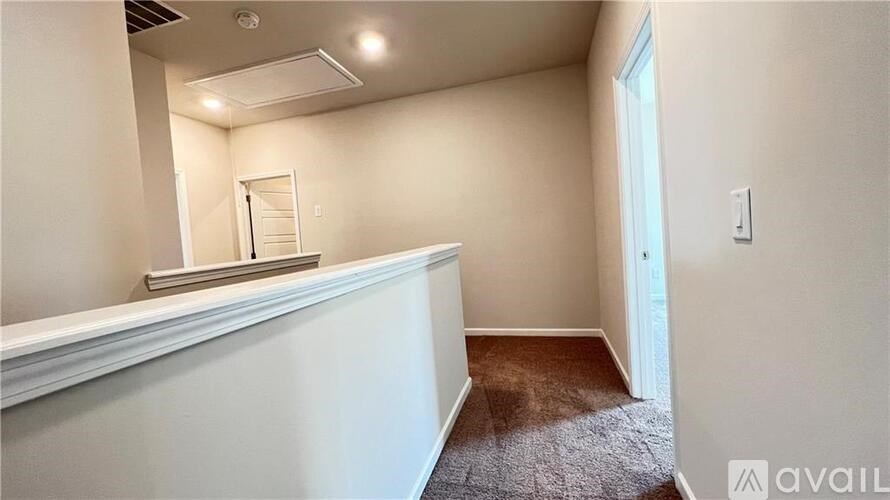 A room with a carpeted floor and a window on the wall.