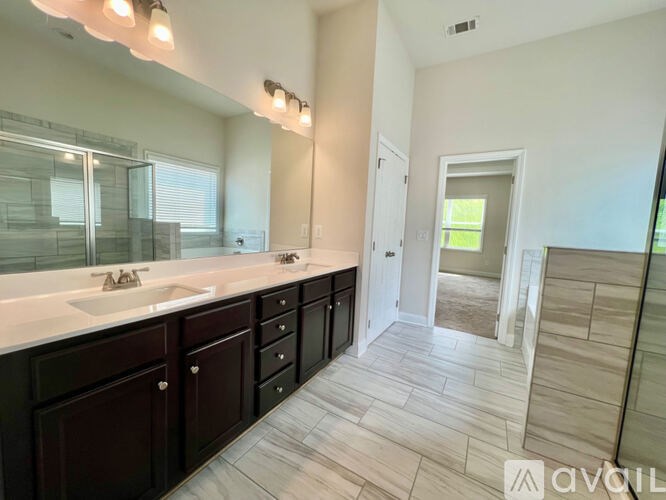 A bathroom with a vanity, sink, and mirror.