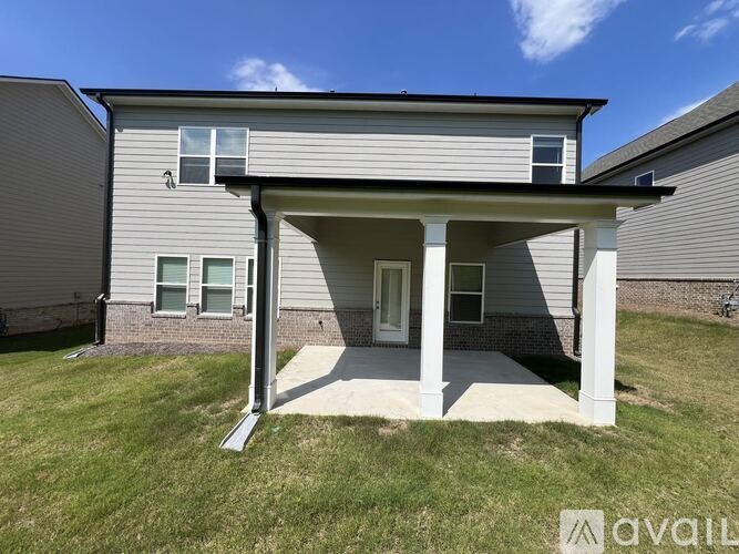 A house with a covered patio area is for sale.