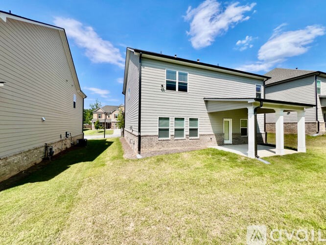 A modern house with a large front yard.