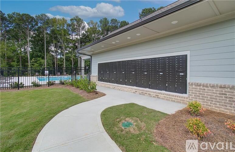 A house with a pool and a fence in the background.