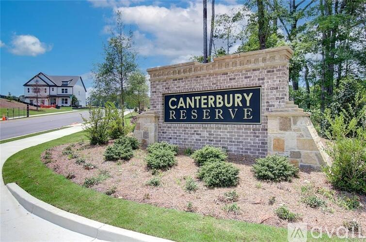A sign that says Canterbury Reserve stands in front of a house.