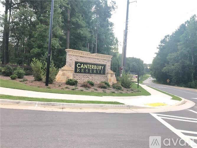 A sign for the Canterbury Reserve stands in front of a road.