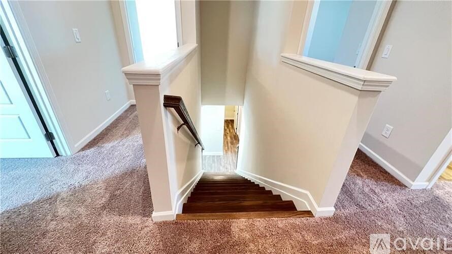 A staircase with a carpeted floor and white walls.