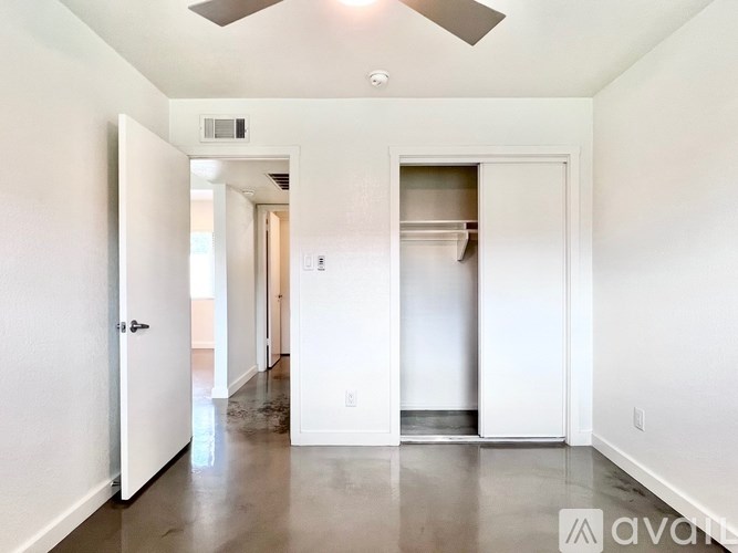 A white room with a doorway leading to another room.