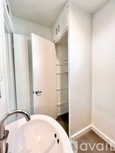 A white sink in a small bathroom.