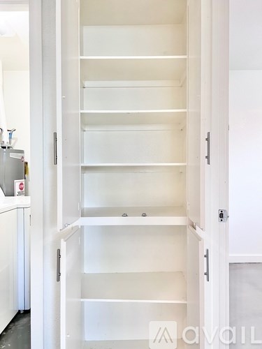 A white door with a handle and a shelf.