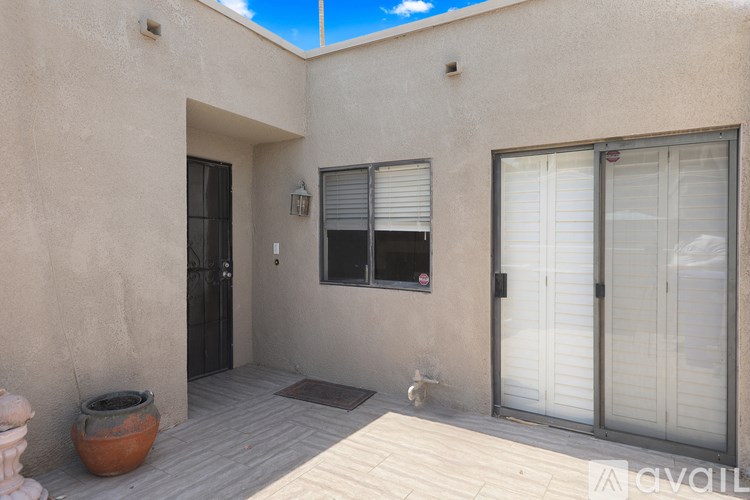 A sunny day at a house with a terrace and a balcony.