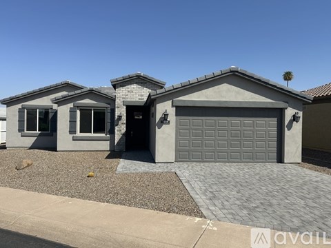 A house with a grey garage door is for sale.