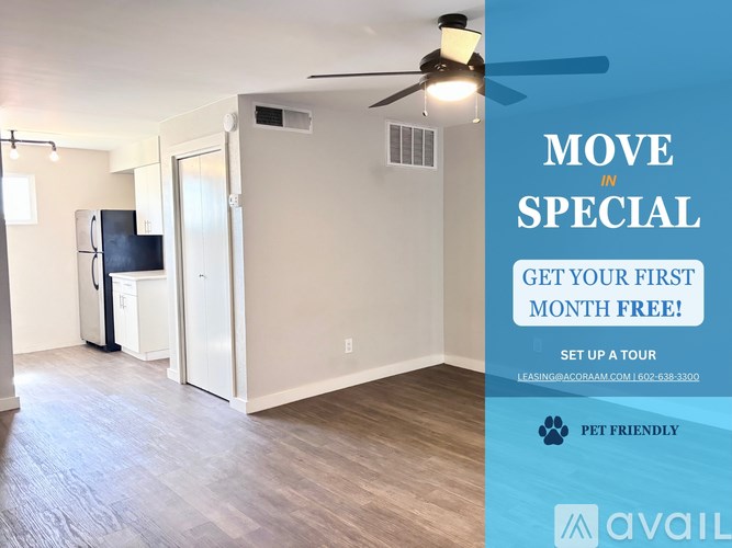 A room with a refrigerator and a ceiling fan with a sign offering a free first month of rent.