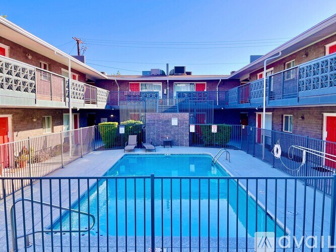A pool surrounded by a fence in a courtyard.