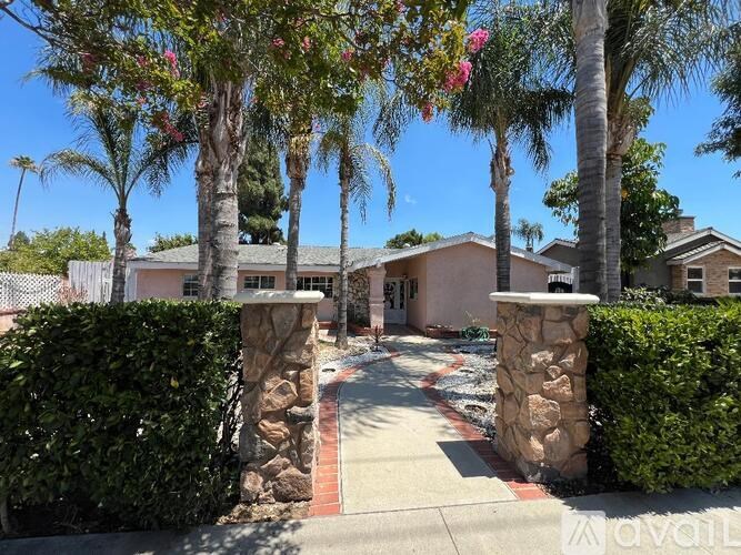 A house with a stone pillar in front of it.