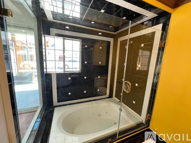 A bathroom with a tub and a shower stall.