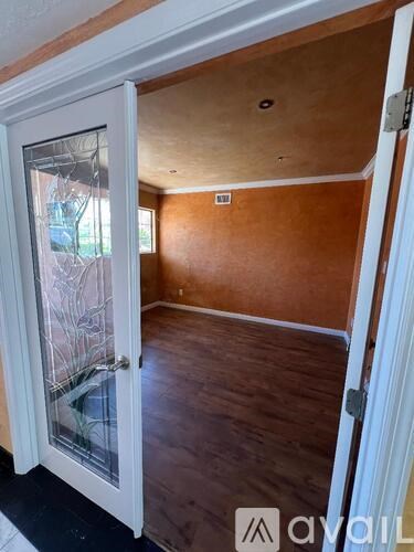 A room with wooden walls and a white door.