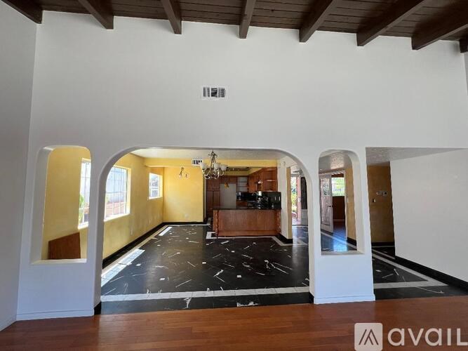 A spacious room with a black and white checkered floor.