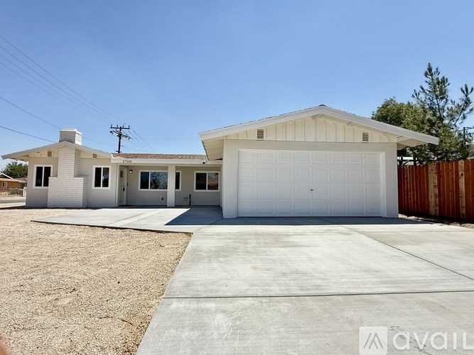 A two-story house with a garage is available for rent.