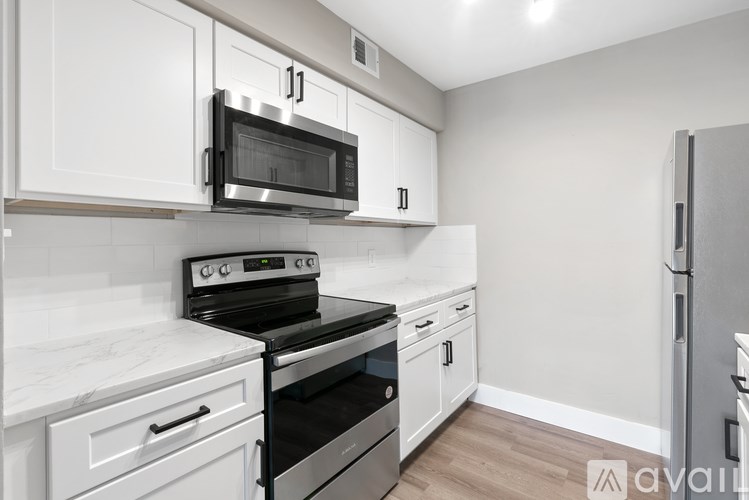 A kitchen with a stove, oven, and refrigerator.
