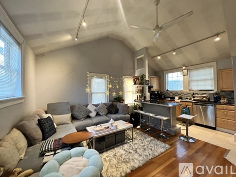 A living room with a grey couch and a coffee table.
