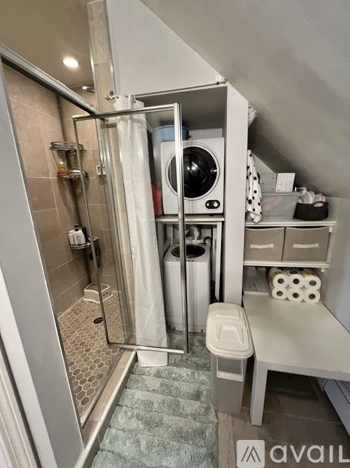 A small bathroom with a washing machine built into the wall.