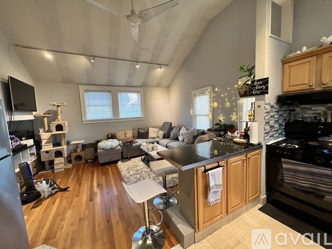 A modern kitchen with wooden cabinets and a black stove top oven.