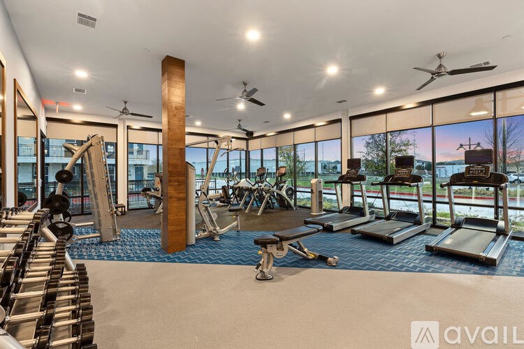 A gym with treadmills, weights, and exercise equipment.
