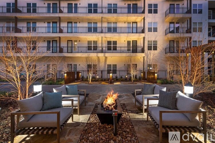 A modern apartment complex with a fire pit in the courtyard.