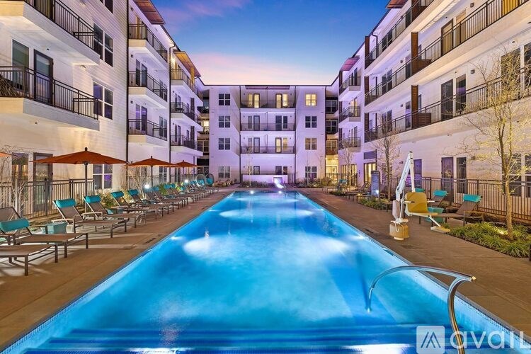 A swimming pool in front of apartment buildings.