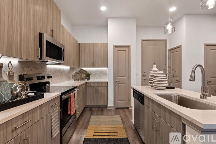 A kitchen with wooden cabinets and a black stove top oven.