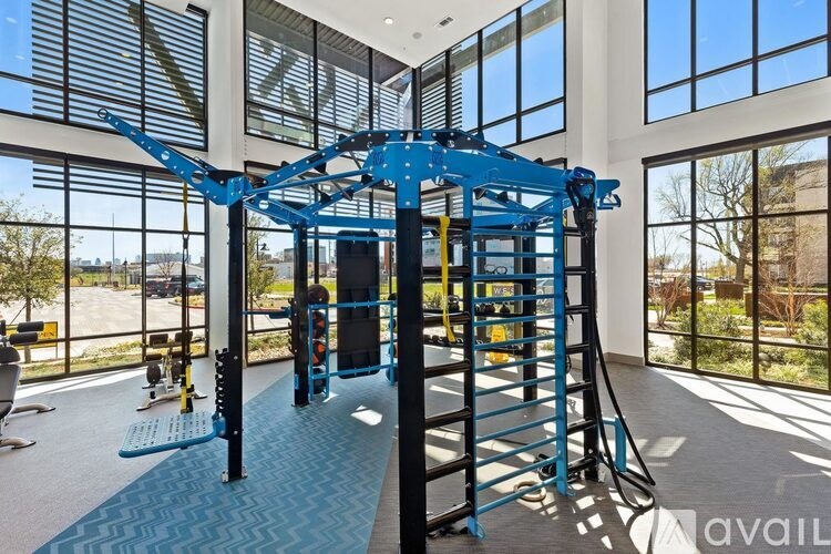 A blue gym equipment in a spacious room with large windows.