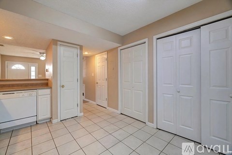 A kitchen with white cabinets and a washer and dryer.