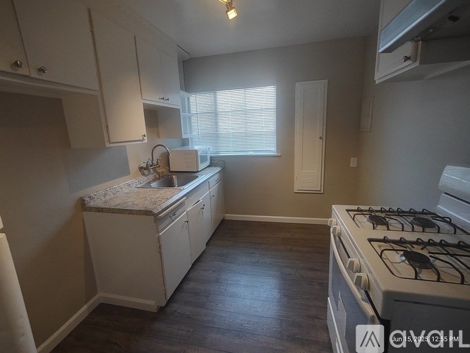 A kitchen with a white countertop and a gas stove.