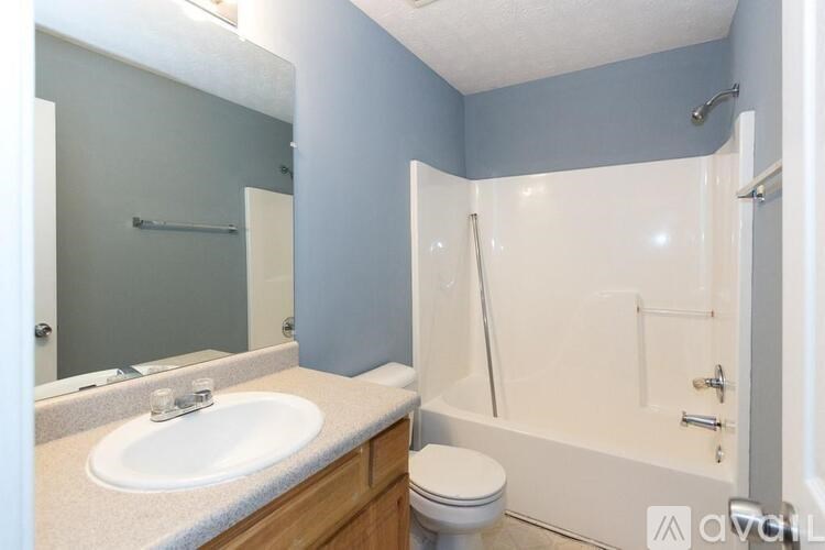A bathroom with a sink, toilet, and bathtub.
